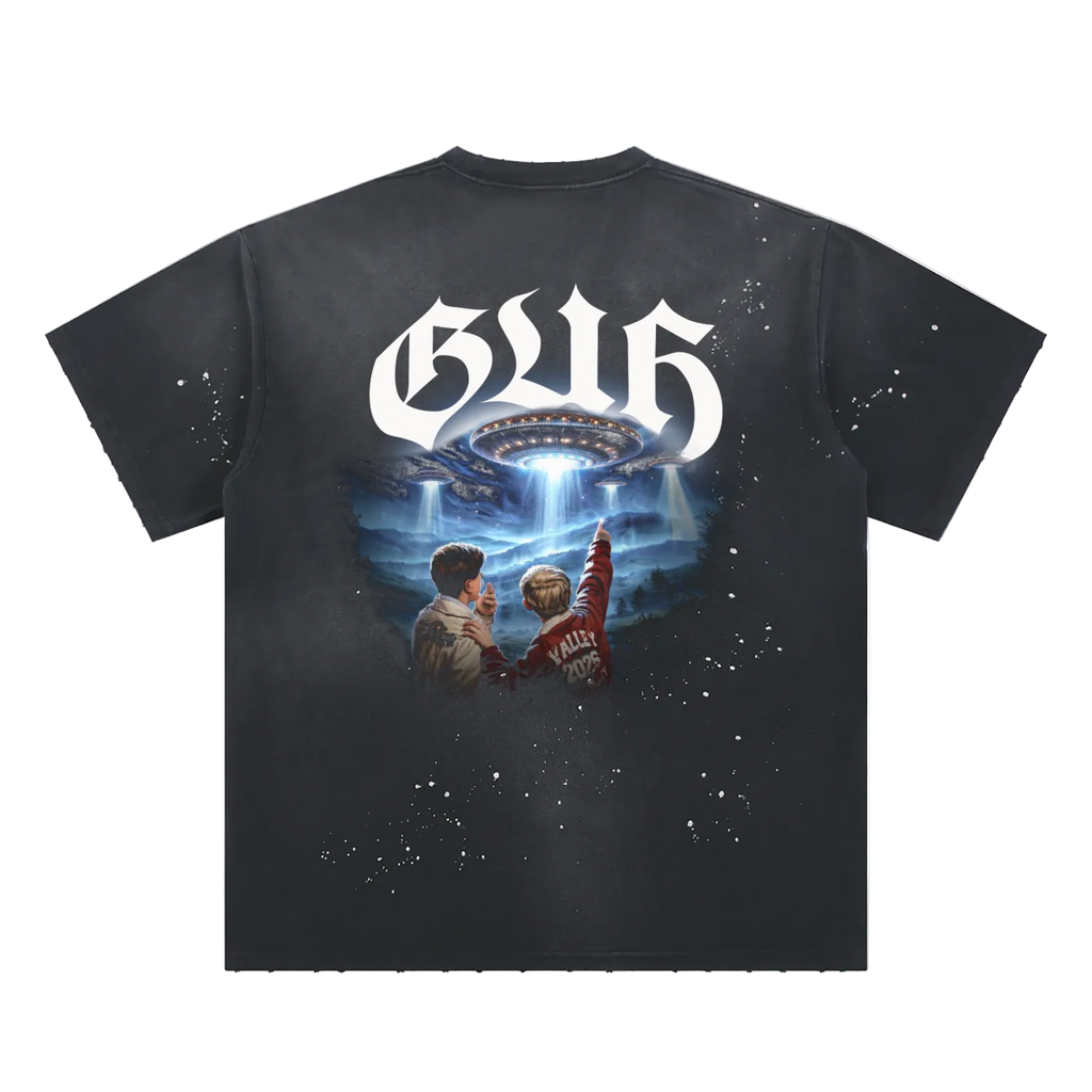 Black t-shirt with a graphic design of two people looking at a UFO and the text 'GUF' on a white background.