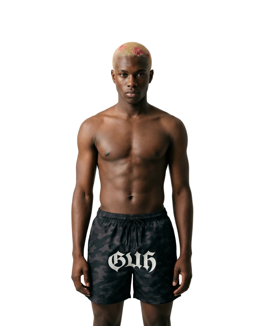 Man wearing black swim shorts with 'Gus' logo on a beige background